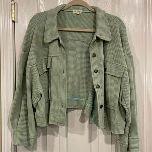 Cute button details, distressed edges, waffle fabric.